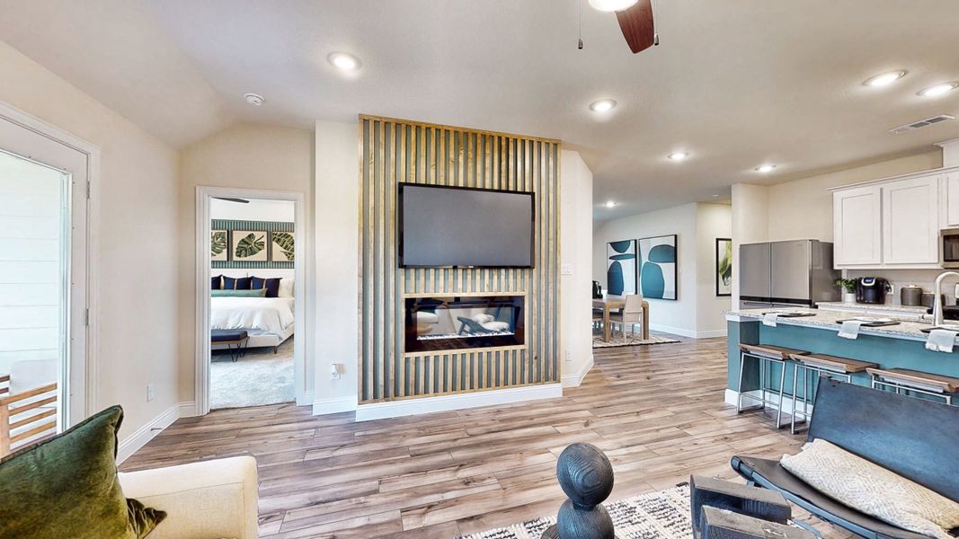A living room with a tv and a couch. A living room with a tv and a couch.