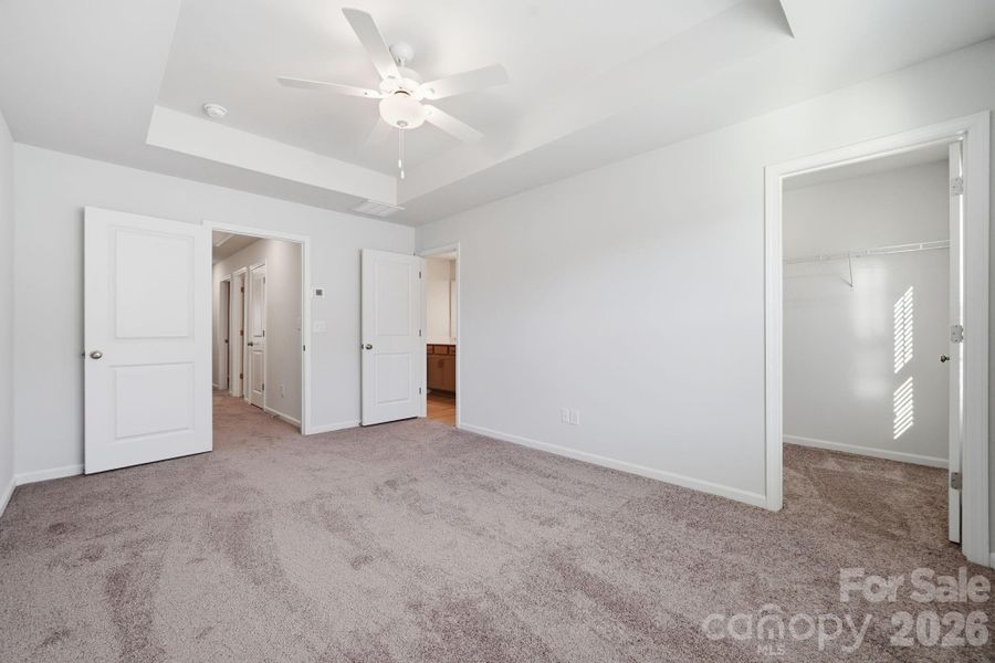 Primary Bedroom with 9' Tray Ceiling Primary Bedroom with 9' Tray Ceiling