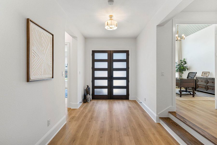High ceilings paired with stunning white oak hardwood floors make a striking first impression as you step into this exceptional home.
