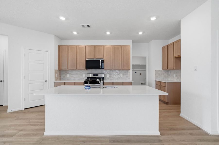 This spacious kitchen has it all—ample storage, generous counter space, and a layout that truly makes it the heart of the home.