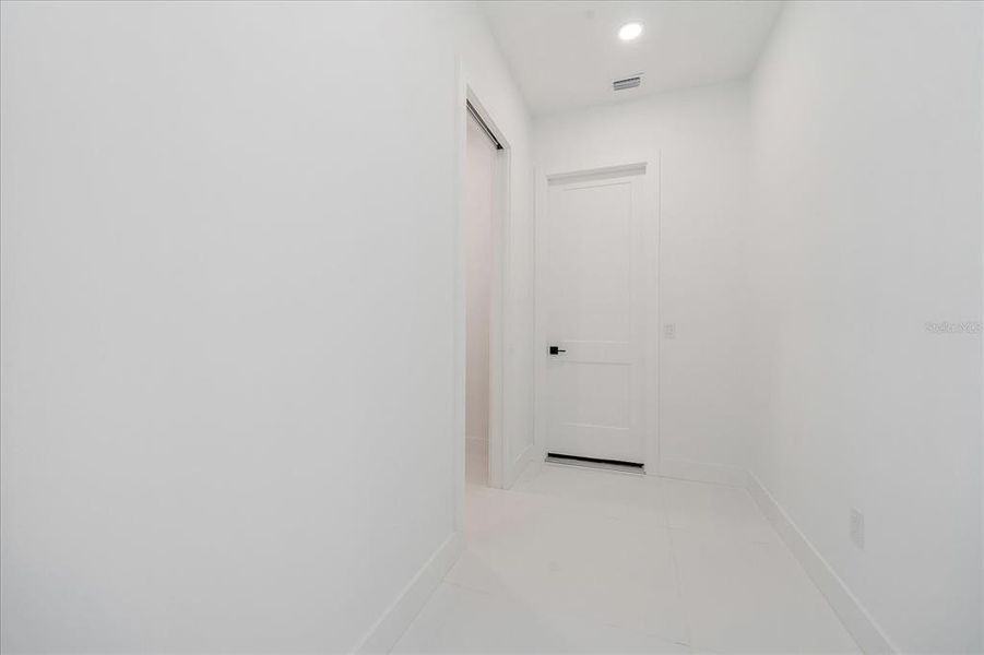 Hallway to the garage and laundry to the left