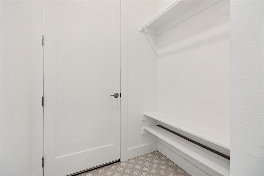 Walk in closet with light tile patterned flooring