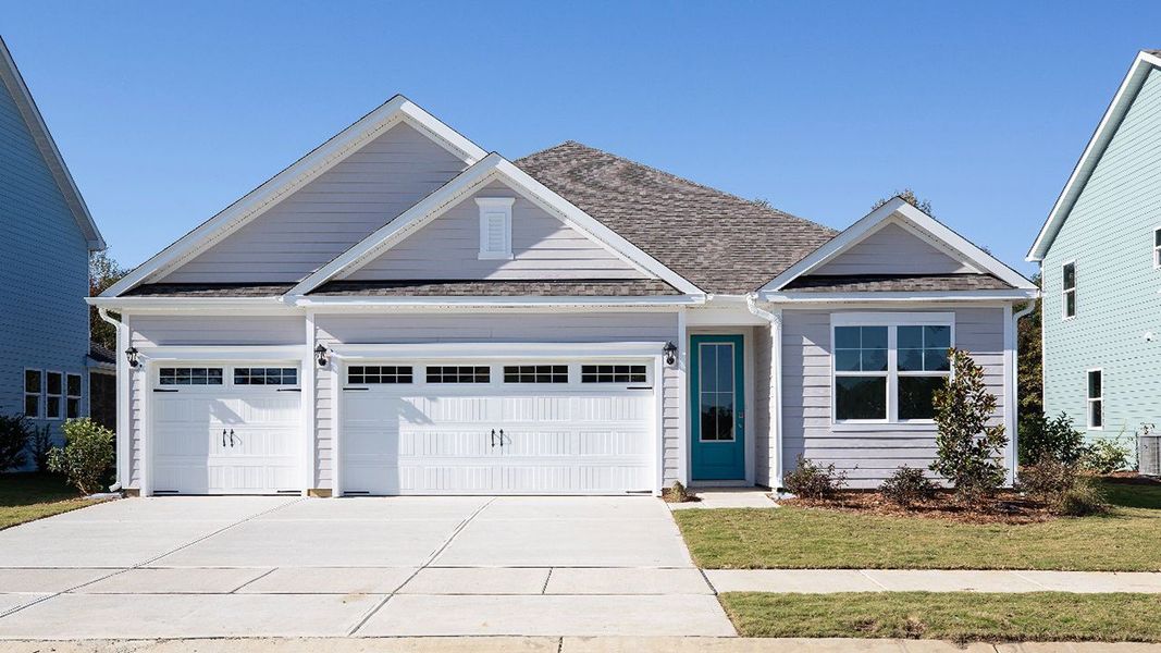 Front exterior of a new home in Indigo Preserve, Leland, NC, highlighting curb appeal (Image 1).