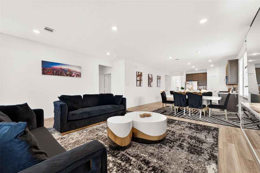 Spacious open-concept living and dining area designed for both everyday comfort and entertaining. Featuring luxury vinyl plank flooring, recessed lighting, and seamless flow into the kitchen, this inviting space offers a modern aesthetic with versatile layout options