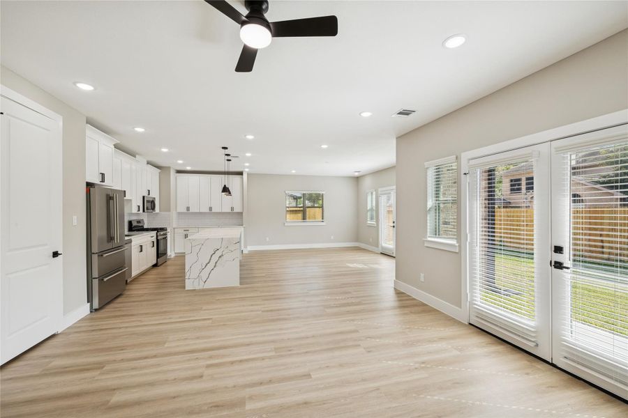 Spacious and inviting family room with abundant natural light and seamless flow to the kitchen and backyard.