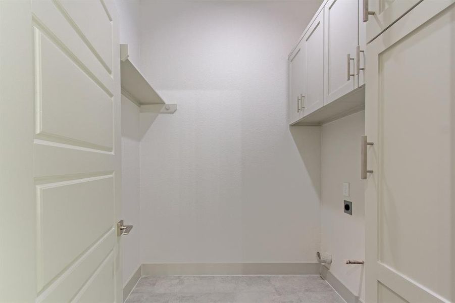 Utility room with extra shelves and cabinetry.