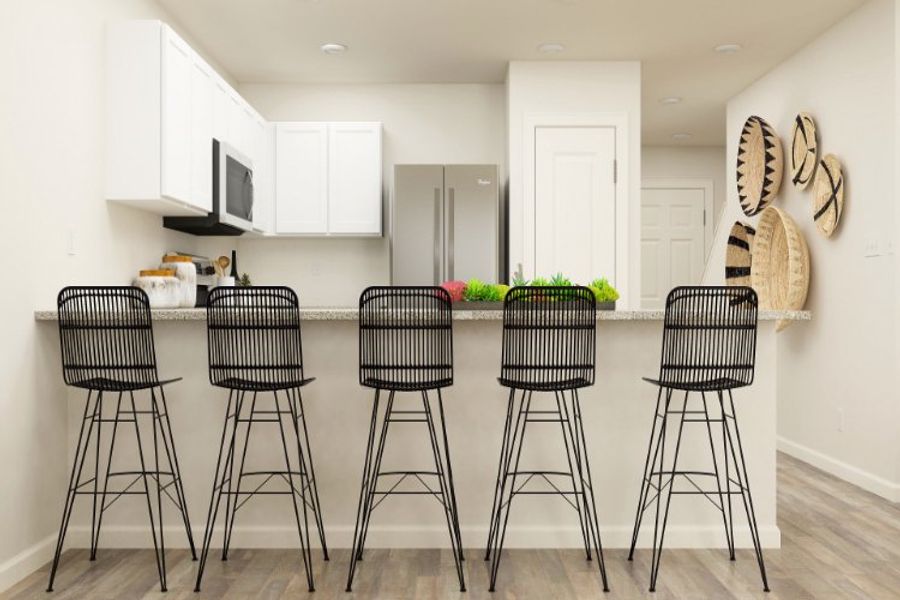 A kitchen with stools and a table.