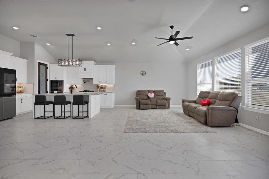 Living room with marble finish floor, recessed lighting, and baseboards