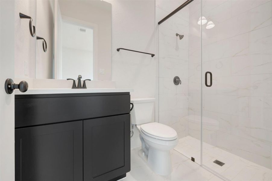 Ensuite bath at 1st floor 2ndary bedroom provides a walk in shower