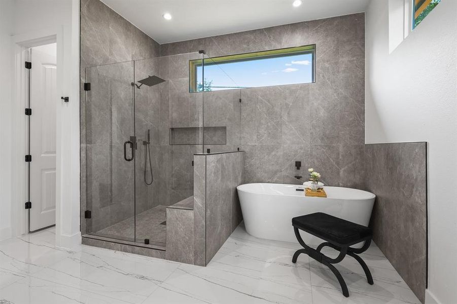 Bathroom featuring tile patterned flooring, tile walls, and independent shower and bath