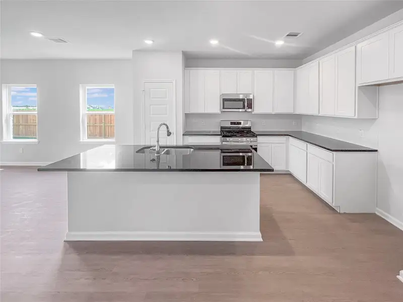 The Waring III- Kitchen with Large Island. Sample image for illustration; upgrades, options, and colors may vary.