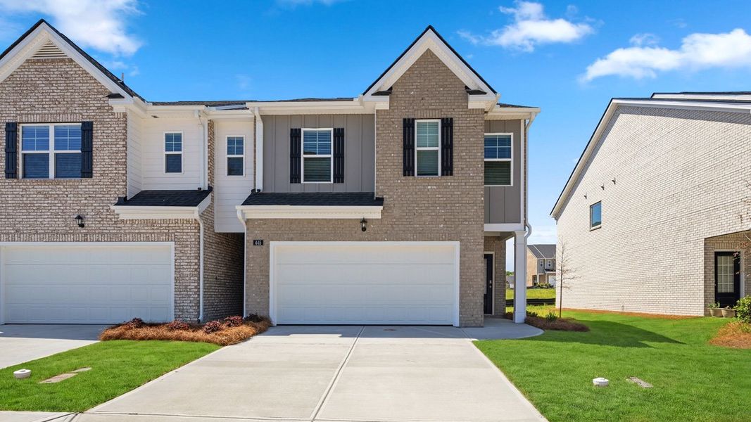 Front exterior of a new home in Independence Villas and Townhomes, Loganville, GA, highlighting curb appeal (Image 2). Front exterior of a new home in Independence Villas and Townhomes, Loganville, GA, highlighting curb appeal (Image 2).