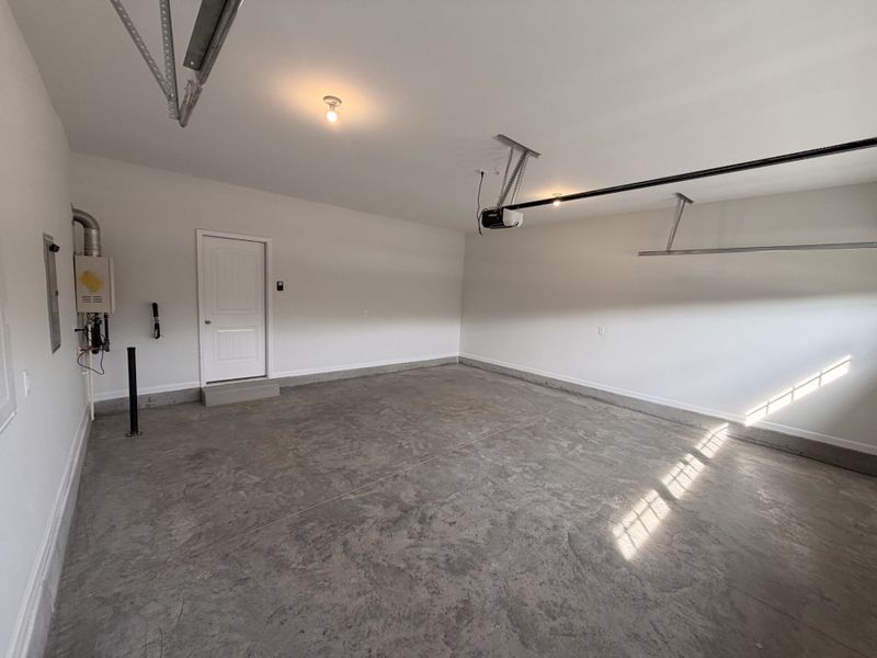 Garage comes fully finished with insulated walls, painted ceiling and even baseboard trim surrounding the space!