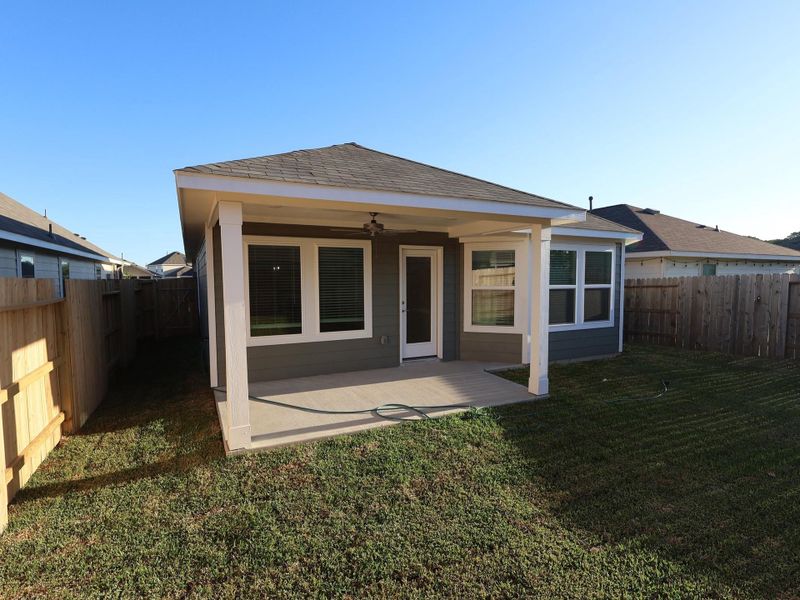 Exterior details and patio area of a home in Pinewood at Grand Texas, New Caney (Image 18).