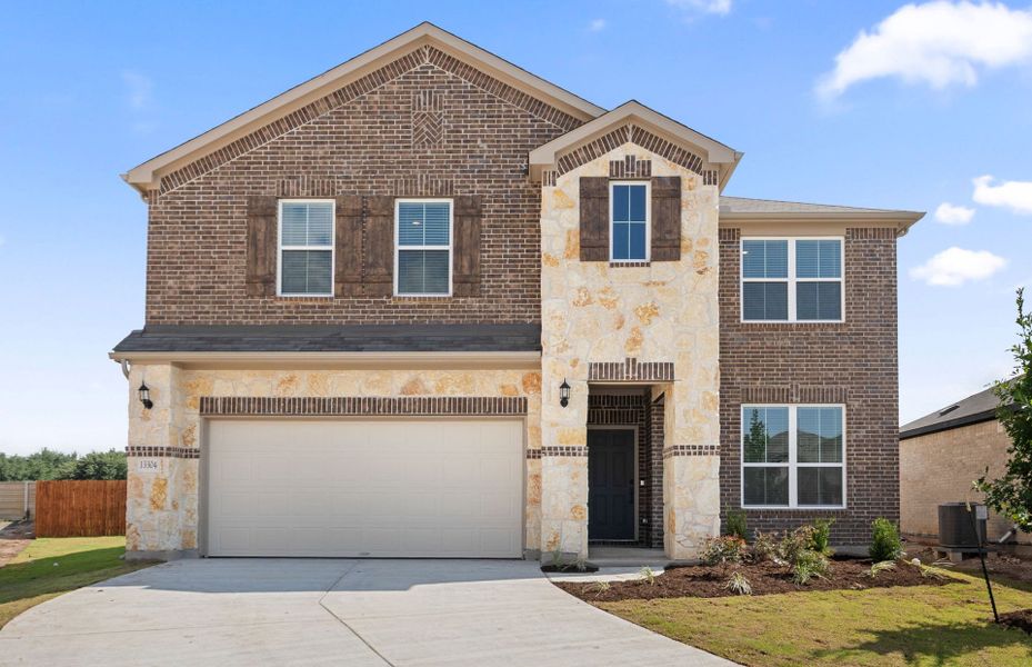 Front exterior of a new home in Lagos, Manor, TX, highlighting curb appeal (Image 23). Front exterior of a new home in Lagos, Manor, TX, highlighting curb appeal (Image 23).