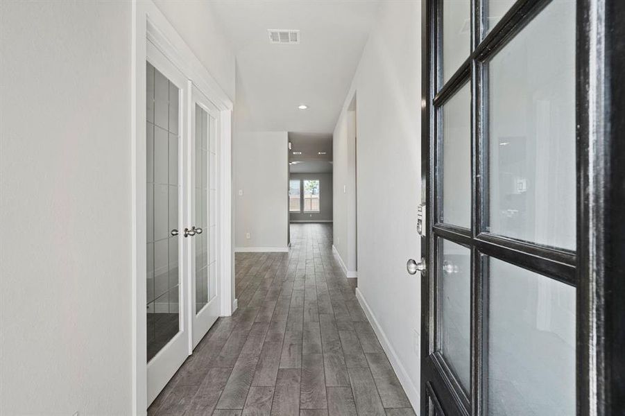 Upon entering, you step into a spacious entryway that seamlessly connects to the home office, dining area, kitchen, and living room. This inviting space offers a warm welcome and a smooth flow throughout the home, making it perfect for both entertaining and eve