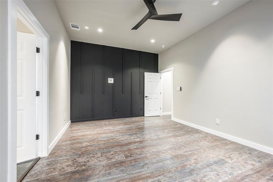 Spare room featuring wood finished floors, ceiling fan, and recessed lighting