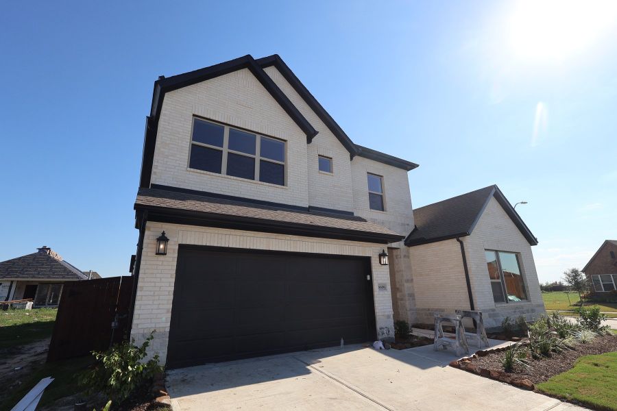 Front exterior of a new home in Meridiana - Ascent Collection, Manvel, TX, highlighting curb appeal (Image 18).