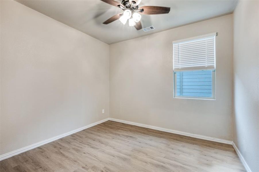 Unfurnished room with light wood finished floors and ceiling fan