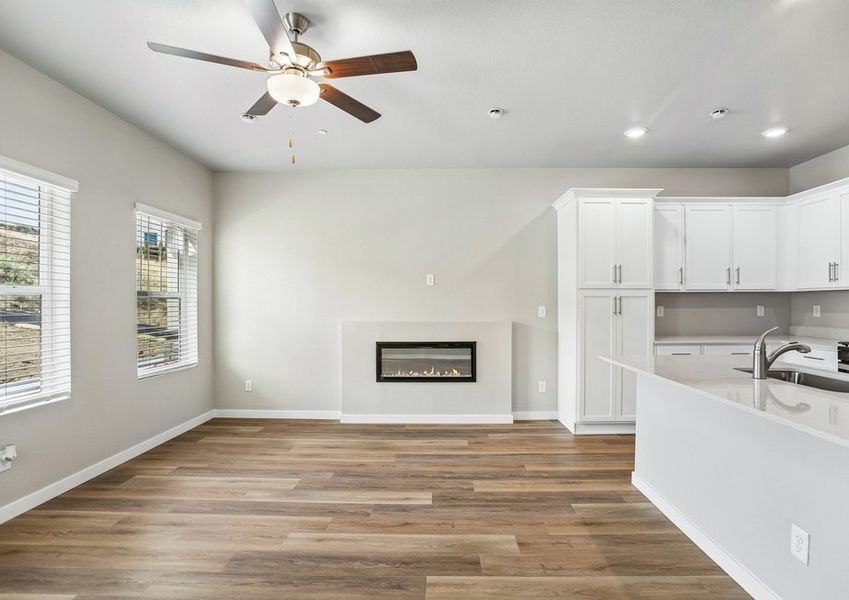 The family room is spacious with a ceiling fan and fireplace. The family room is spacious with a ceiling fan and fireplace.