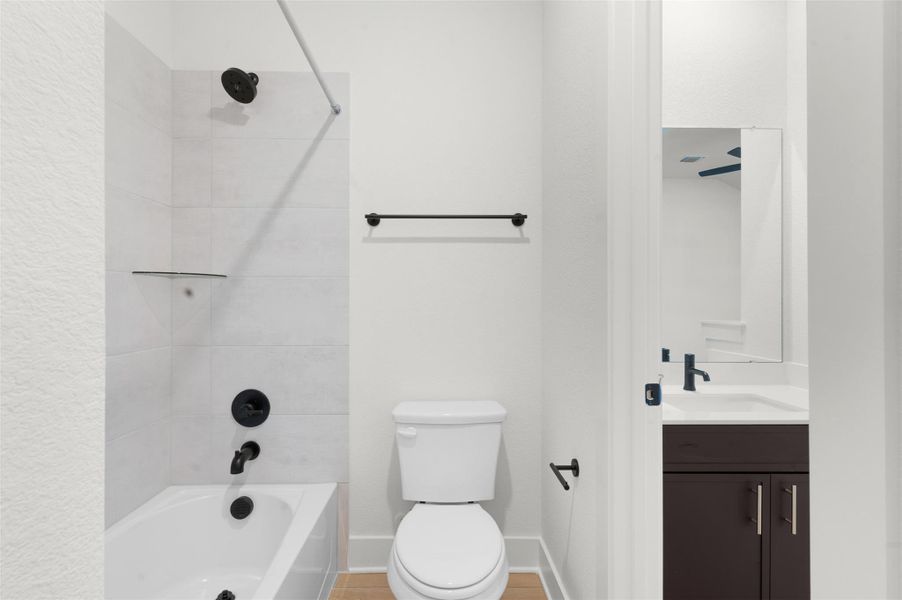 Bathroom with vanity and bathing tub / shower combination