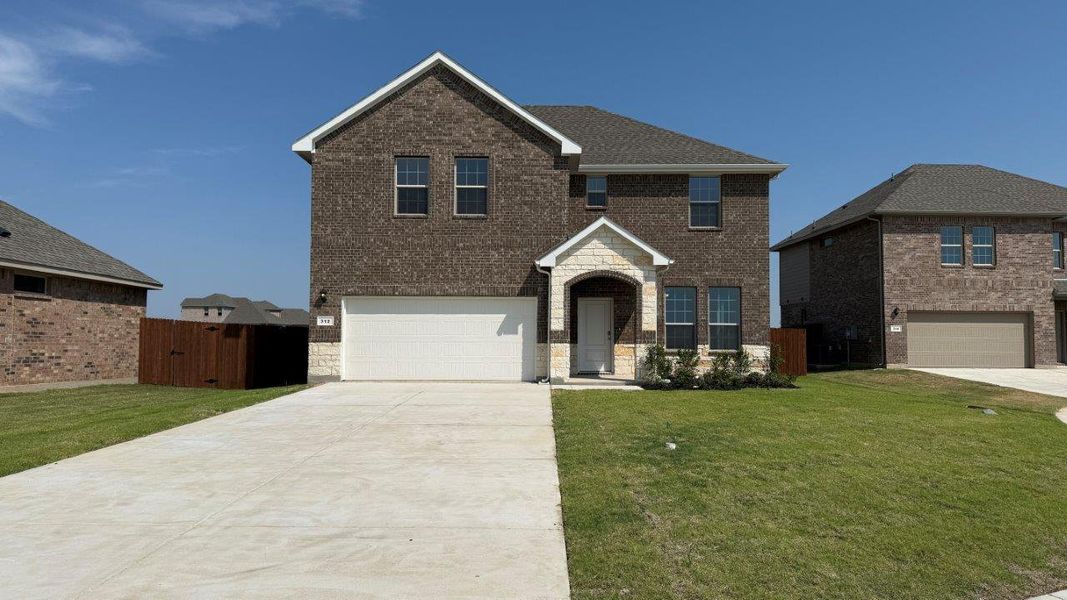 Front exterior of a new home in Saratoga, Granbury, TX, highlighting curb appeal (Image 1). Front exterior of a new home in Saratoga, Granbury, TX, highlighting curb appeal (Image 1).