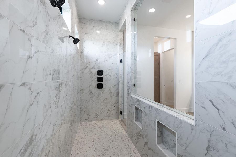 Bathroom featuring a marble finish shower and recessed lighting