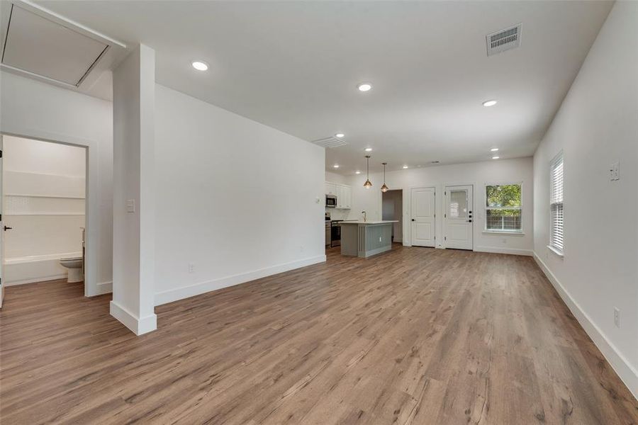 Unfurnished living room with recessed lighting and dark wood-style flooring Unfurnished living room with recessed lighting and dark wood-style flooring