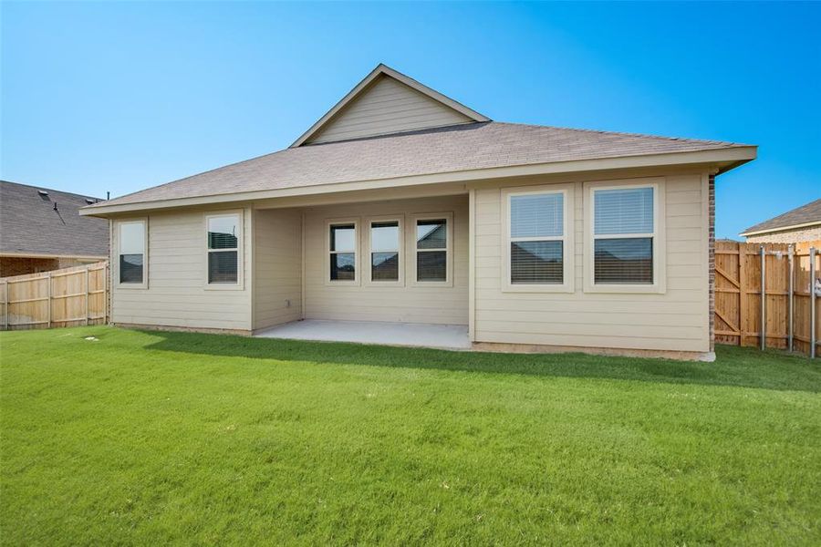 Rear view of property with a patio area and a yard