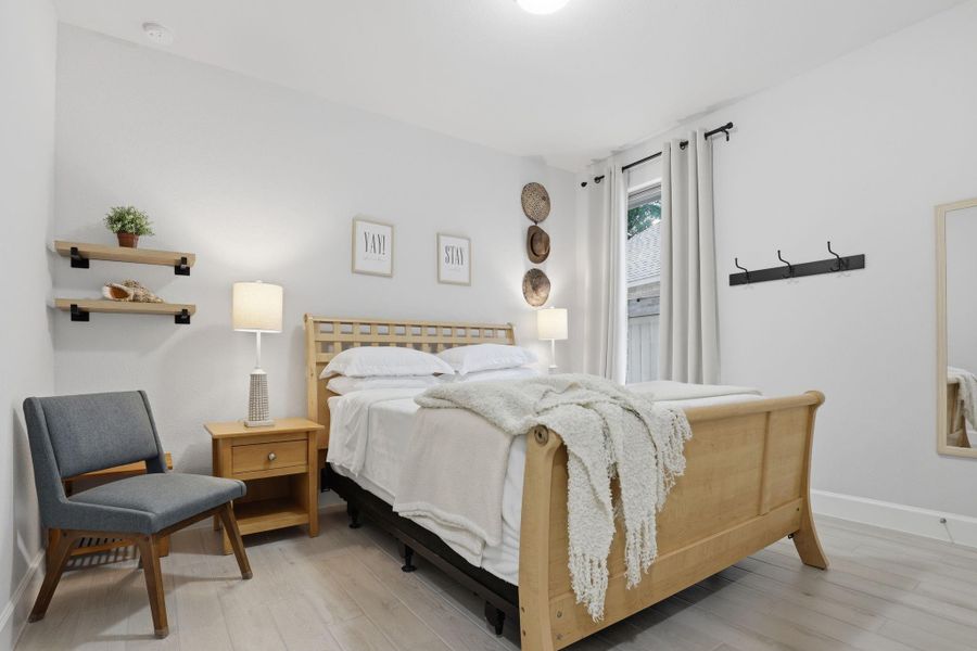 This large, flexible bedroom space comfortably accommodates guest furniture or functions as a secondary office.