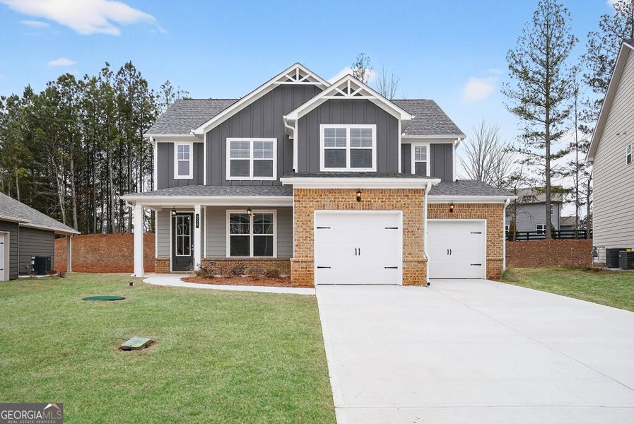 Front exterior of a new home in The Fairways at Mirror Lake, Villa Rica, GA, highlighting curb appeal (Image 1). Front exterior of a new home in The Fairways at Mirror Lake, Villa Rica, GA, highlighting curb appeal (Image 1).