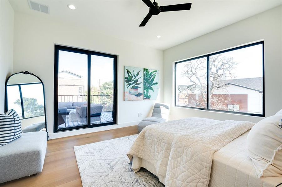 Bedroom with access to outside, light hardwood / wood-style flooring, and ceiling fan