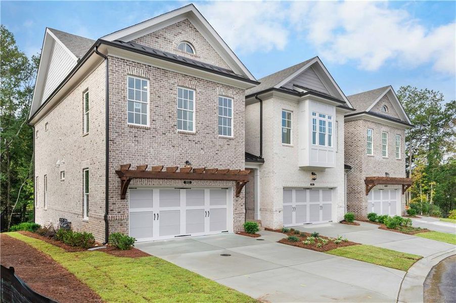Front exterior of a new home in Ward's Crossing Townhomes, Johns Creek, GA, highlighting curb appeal (Image 2). Front exterior of a new home in Ward's Crossing Townhomes, Johns Creek, GA, highlighting curb appeal (Image 2).