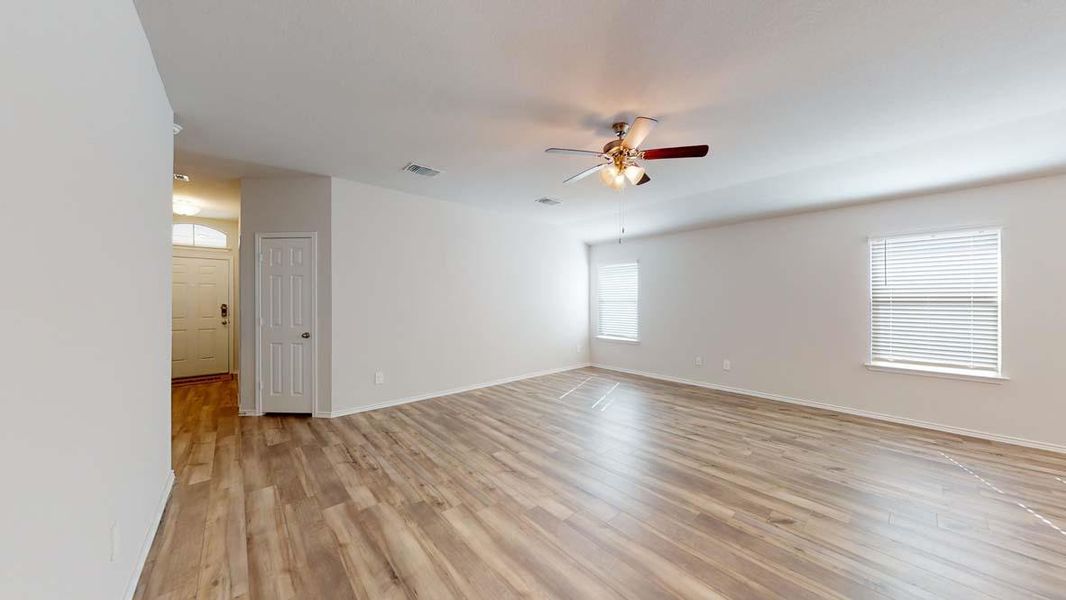 Empty room with light wood-style flooring and a ceiling fan