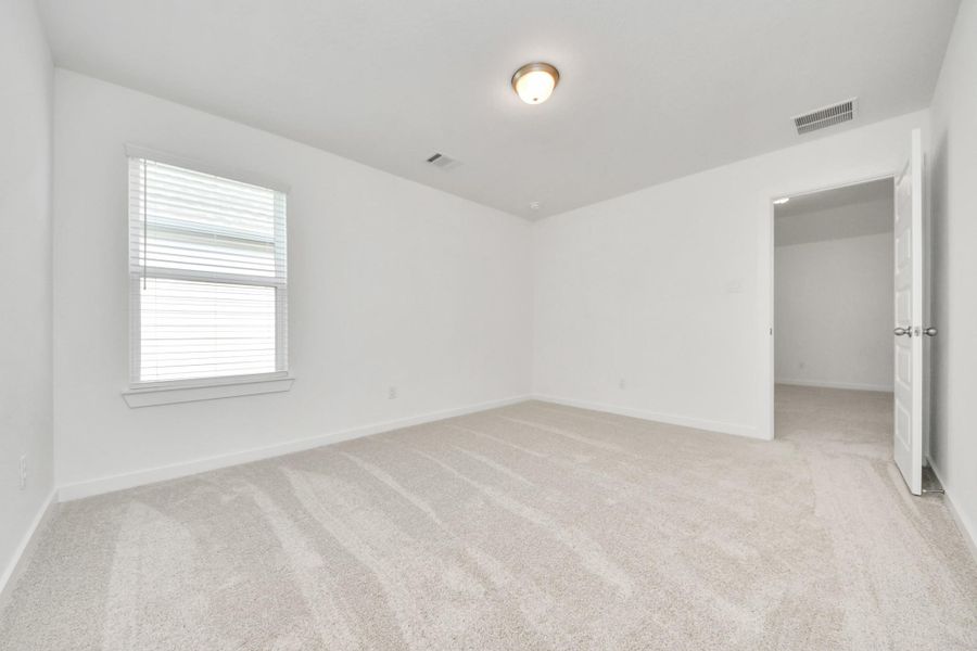 Generously sized secondary bedrooms featuring spacious closets, soft and inviting carpeting underfoot, large windows allowing plenty of natural light, and the added touch of privacy blinds for your personal retreat.