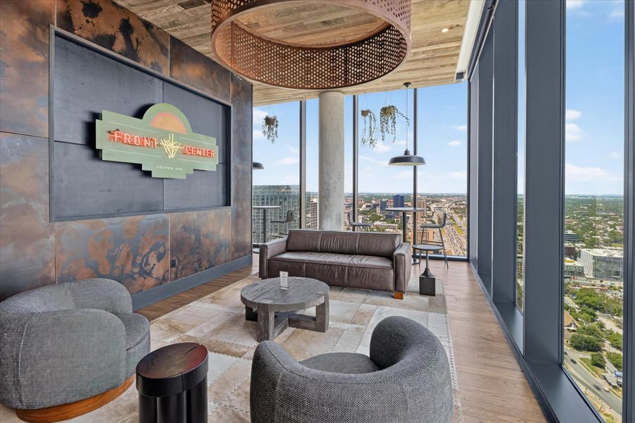 Floor-to-ceiling windows offer vast city views from this well-appointed urban lounge.