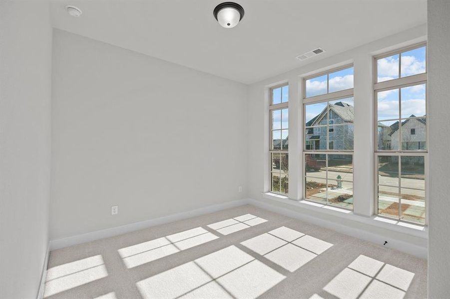 Room featuring light-toned walls, plush carpet flooring, and a semi-flush mount ceiling fixture Room featuring light-toned walls, plush carpet flooring, and a semi-flush mount ceiling fixture