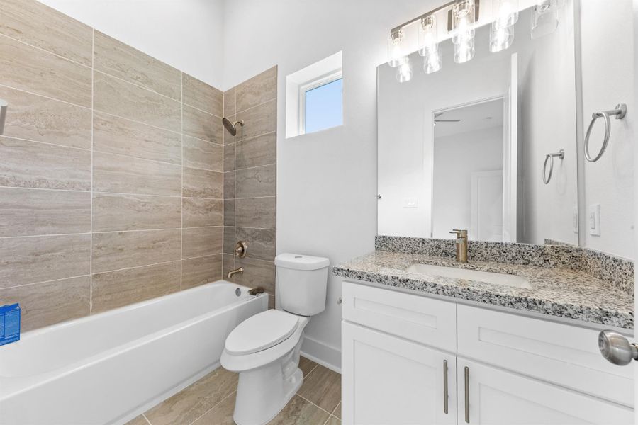 Another full bathroom with modern finishes, sleek vanity, and a clean, polished look. Another full bathroom with modern finishes, sleek vanity, and a clean, polished look.