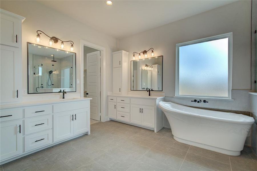 Bathroom featuring tile floors and vanity