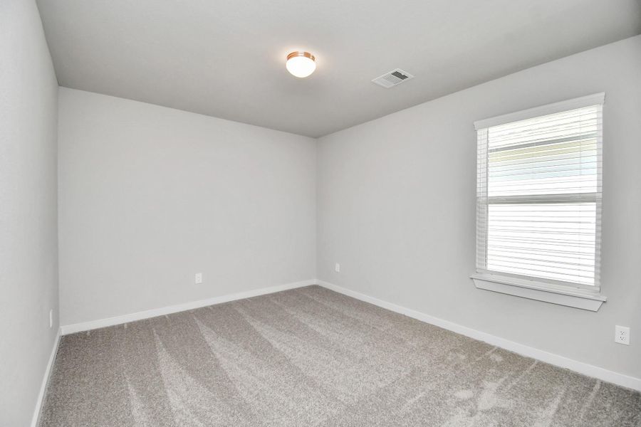 Generously sized secondary bedrooms featuring spacious closets, soft and inviting carpeting underfoot, large windows allowing plenty of natural light, and the added touch of privacy blinds for your personal retreat. Sample photo of completed home with similar floor plan. Actual colors and selections may vary.
