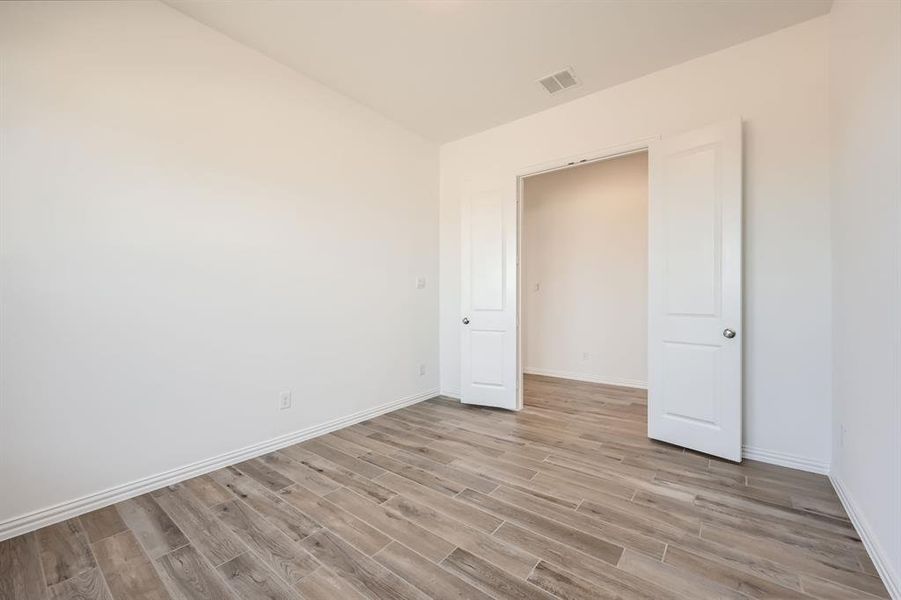 Unfurnished bedroom featuring light hardwood / wood-style floors