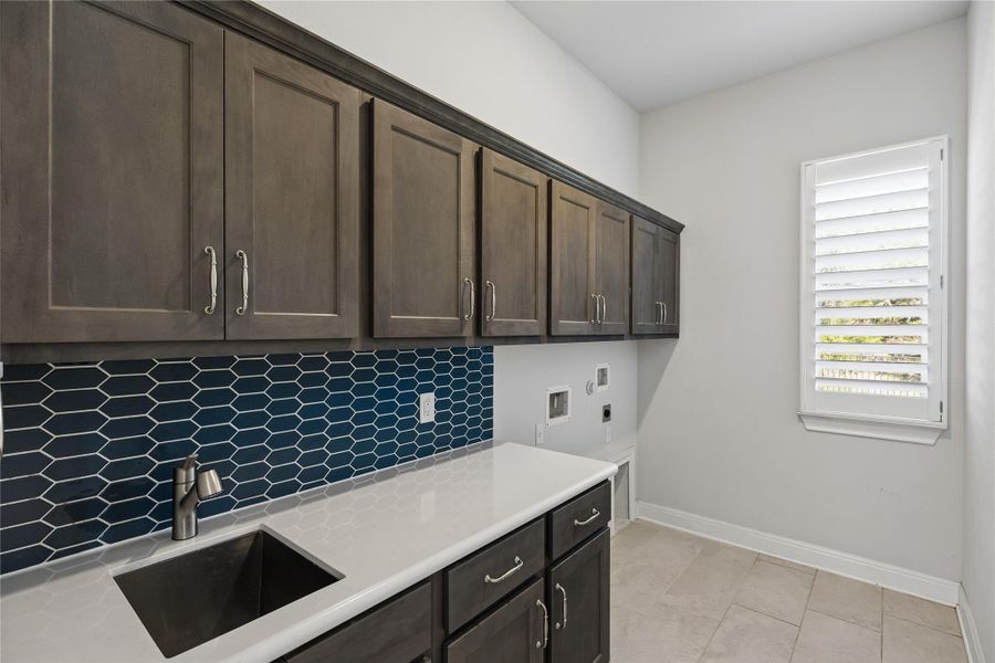 Ample storage and a dedicated sink elevate this functional utility space.