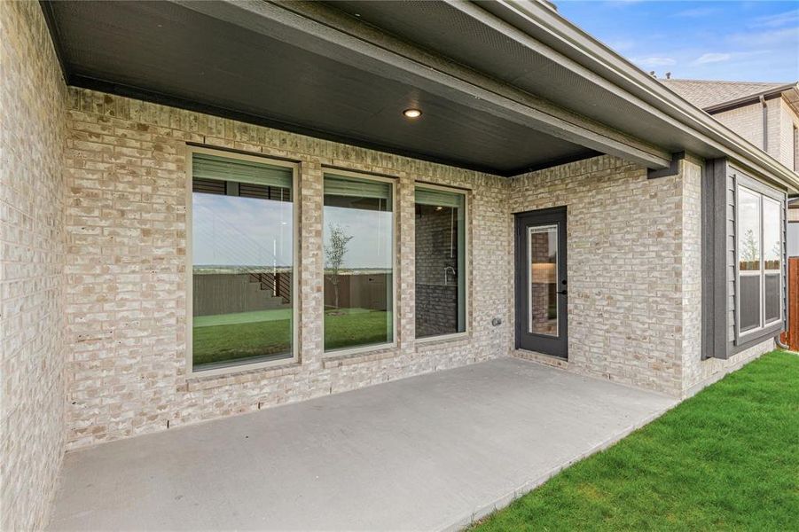 This spacious roof-covered patio is a wonderful place to enjoy your morning coffee.