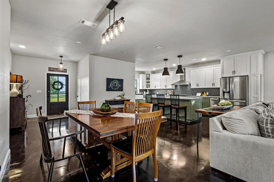 Dining area with finished concrete floors and recessed lighting Dining area with finished concrete floors and recessed lighting