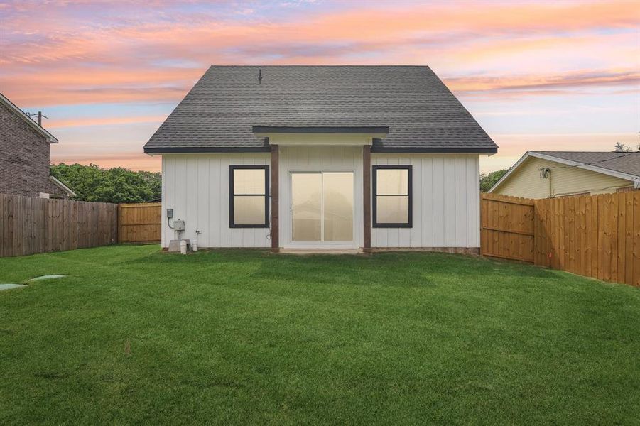 Back of home. Full sod, wood privacy fence.