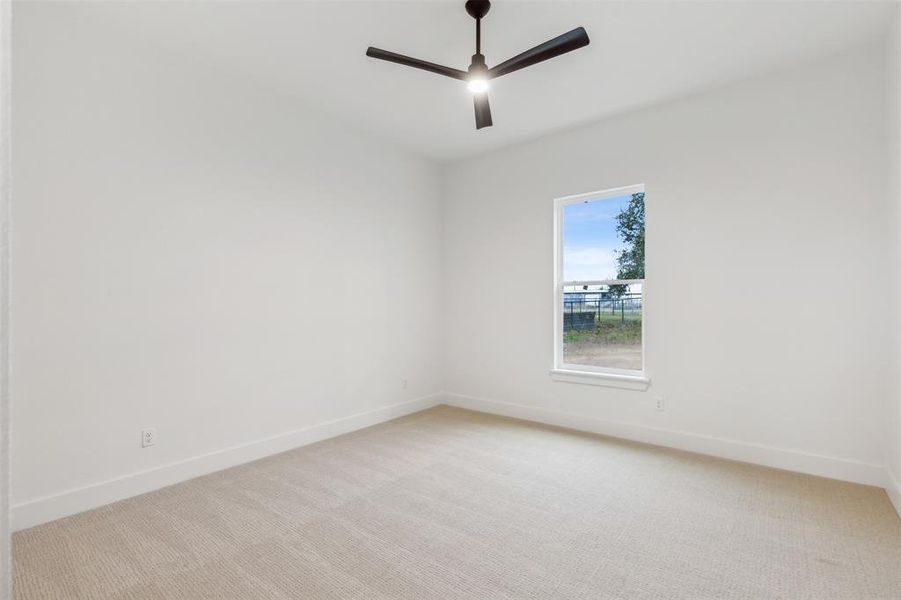 Spare room with light colored carpet and ceiling fan