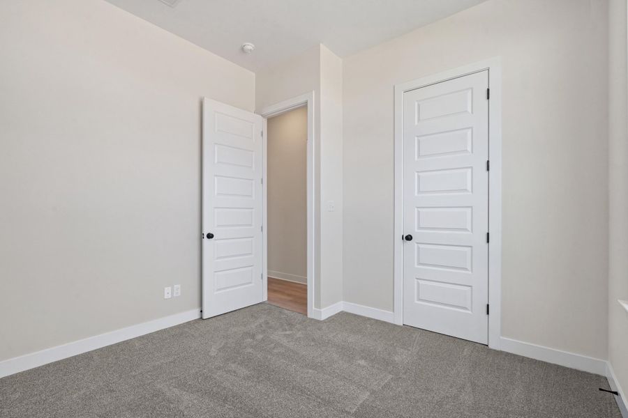 Unfurnished bedroom with carpet and a closet