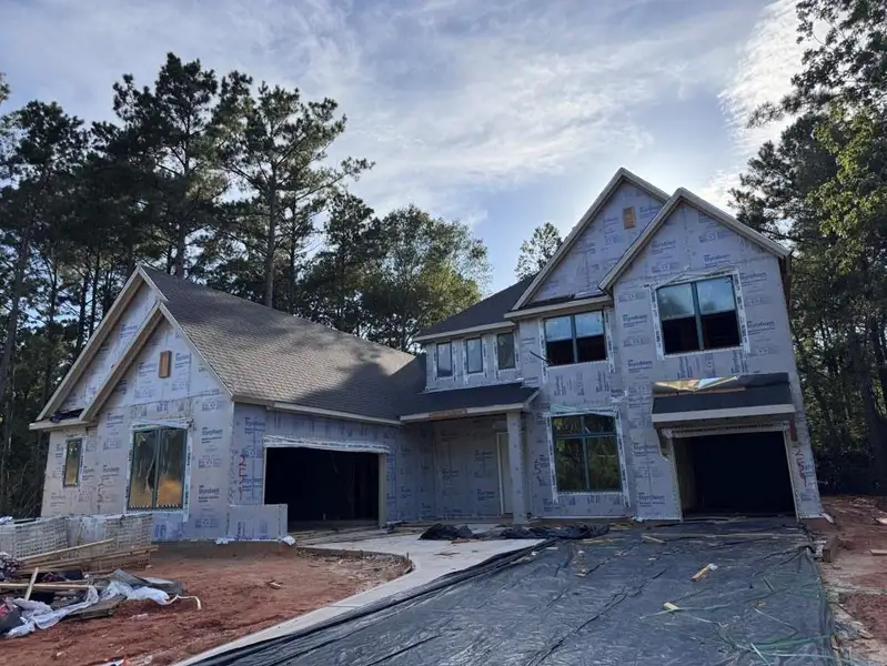Front exterior of a new home in The Woodlands Hills 70’, Willis, TX, highlighting curb appeal (Image 1). Front exterior of a new home in The Woodlands Hills 70’, Willis, TX, highlighting curb appeal (Image 1).