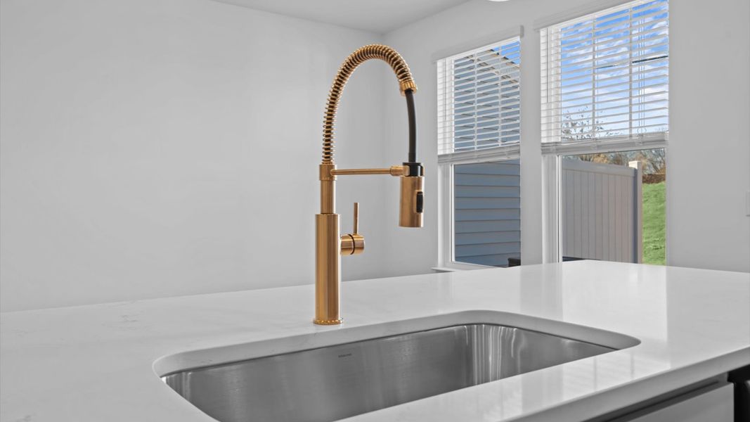 Well-designed kitchen with a large sink and tasteful finishes that elevate everyday living at Silo Ridge townhome community