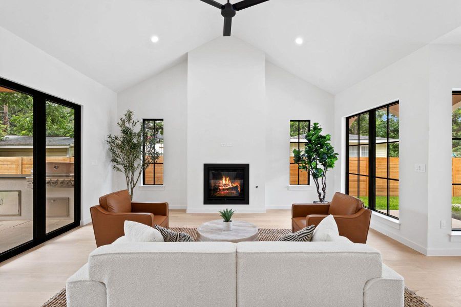 Lofty ceilings and a sleek fireplace create a bright and airy living space. Lofty ceilings and a sleek fireplace create a bright and airy living space.